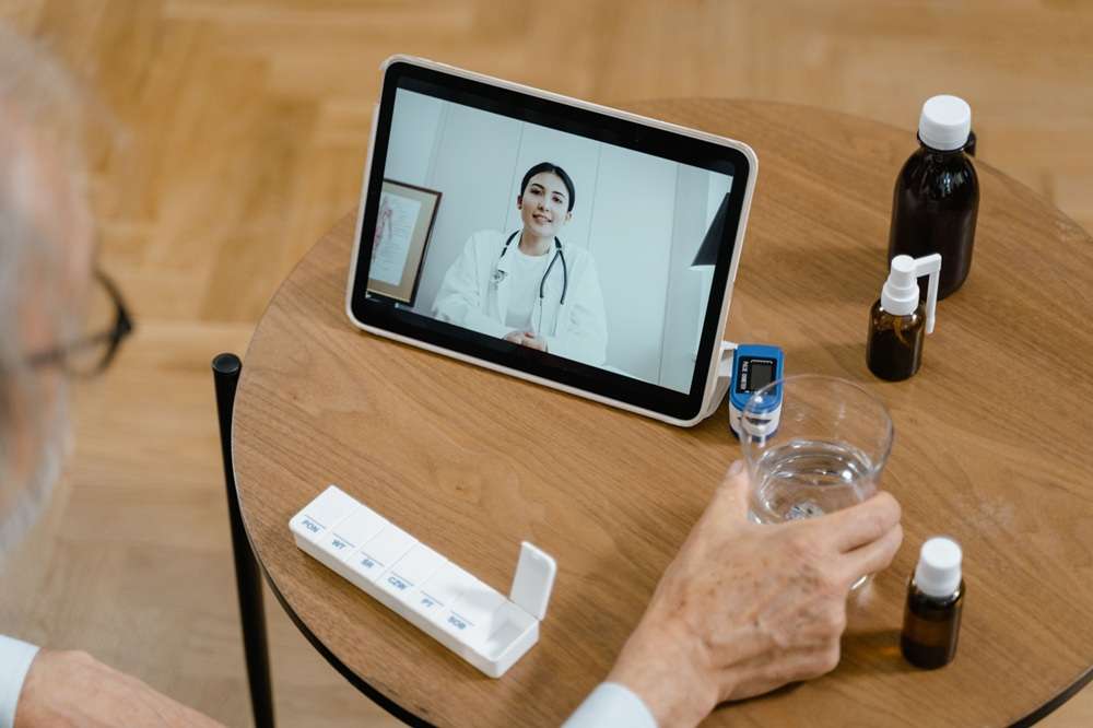 senior care health management smart monitoring https://www.pexels.com/photo/high-angle-shot-of-a-person-making-a-zoom-call-to-a-doctor-8376171/