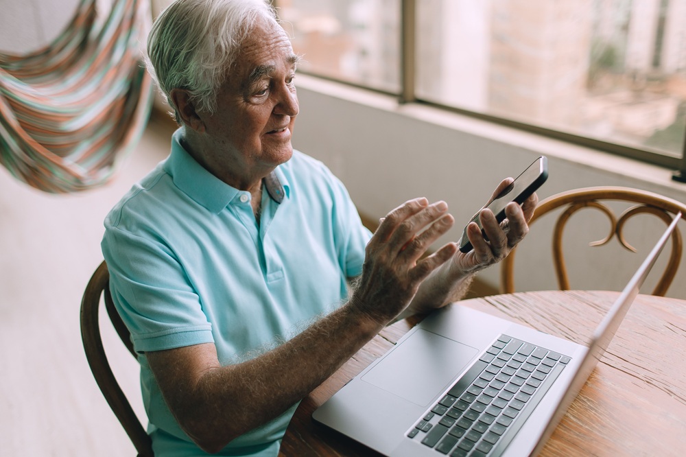 senior elderly tech https://www.pexels.com/photo/an-elderly-man-sitting-at-the-table-using-a-laptop-and-a-smartphone-27086285/
