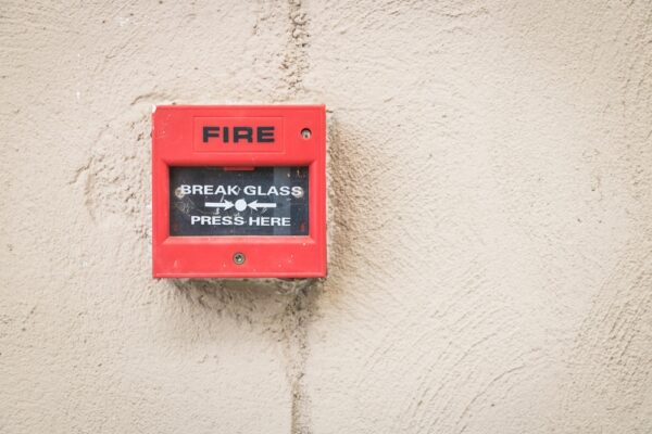 integrated safety system https://www.pexels.com/photo/a-red-and-black-fire-alarm-control-13060860/